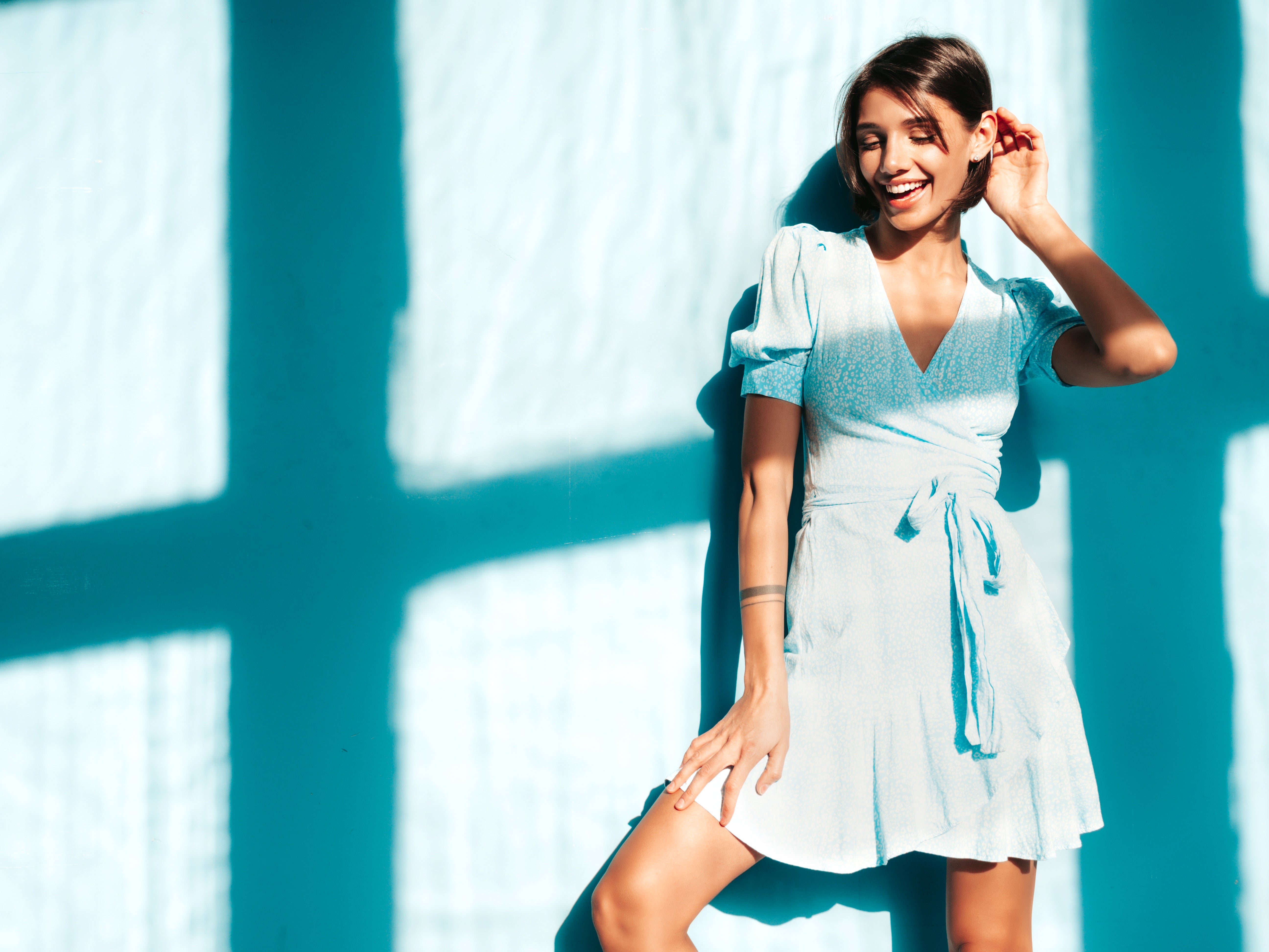 files/young-beautiful-smiling-female-trendy-summer-dress-sexy-carefree-woman-posing-near-blue-wall-studio-positive-model-having-fun-cheerful-happy-sunny-day-shadow-from-window.jpg